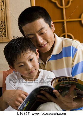 Father and son reading magazine View Large Photo Image Stock Photo - Father and son reading magazine. Fotosearch