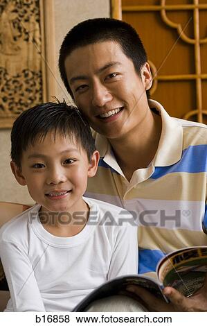 Father and son reading magazine View Large Photo Image Stock Photo - Father and son reading magazine. Fotosearch