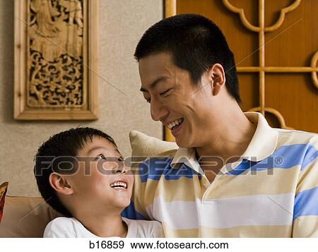 Father and son smiling View Large Photo Image Stock Photo - Father and son smiling. Fotosearch