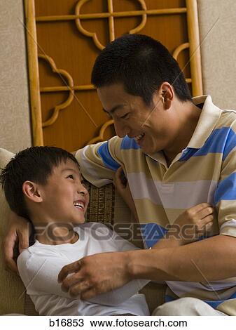 Father and son tickling each other View Large Photo Image Stock Image - Father and son tickling each other. Fotosearch