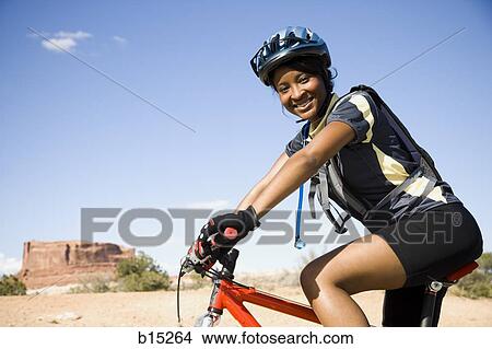 Female cyclist with helmet outdoors smiling View Large Photo Image Picture - Female cyclist with helmet outdoors smiling. Fotosearch