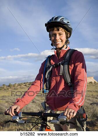 Female cyclist with helmet outdoors smiling View Large Photo Image Stock Image - Female cyclist with helmet outdoors smiling. Fotosearch