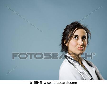 Stock Photography - Female doctor looking up. Fotosearch