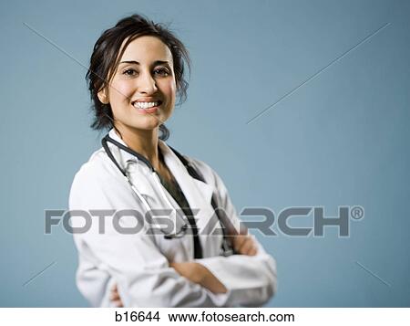 Female doctor with arms crossed smiling View Large Photo Image Picture - Female doctor with arms crossed smiling. Fotosearch
