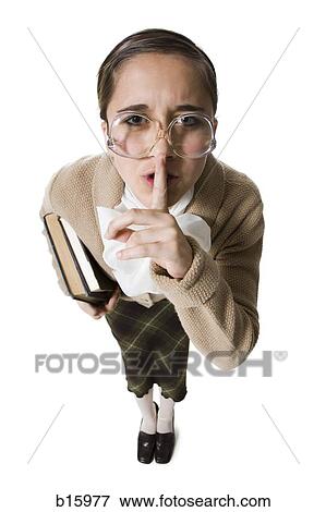 Stock Photo - Female librarian with eyeglasses and books hushing. Fotosearch