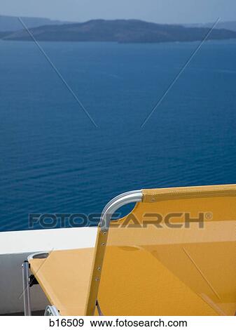 Folding Chair with water and rock formation View Large Photo Image Stock Photo - Folding Chair with water and rock formation. Fotosearch