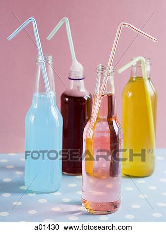 Stock Image - Four soda bottles with straws. Fotosearch