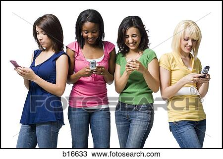 Four women with cell phones smiling View Large Photo Image Stock Image - Four women with cell phones smiling. Fotosearch