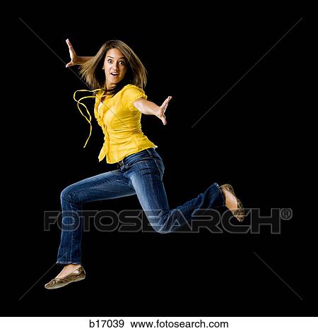 Stock Photo - Full length woman dancing with arms up. Fotosearch