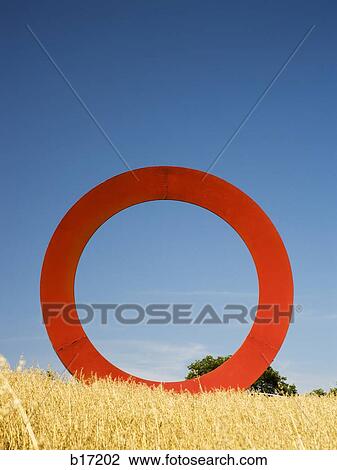 Giant red O in field with blue sky View Large Photo Image Stock Image - Giant red O in field with blue sky. Fotosearch