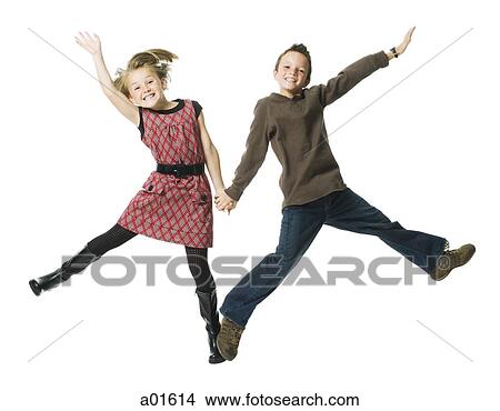 Girl and boy holding hands and leaping with arms up smiling View Large Photo Image Picture - Girl and boy holding hands and leaping with arms up smiling. Fotosearch