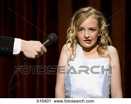 Girl beauty pageant contestant with microphone looking nervous View Large Photo Image Stock Image - Girl beauty pageant contestant with microphone looking nervous. Fotosearch
