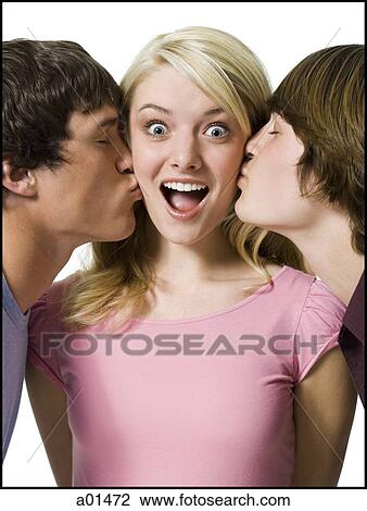 Stock Image - Girl being kissed on both cheeks by two boys. Fotosearch
