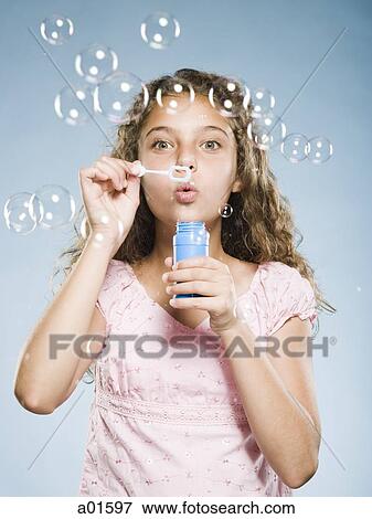 Girl blowing bubbles View Large Photo Image Stock Photo - Girl blowing bubbles. Fotosearch
