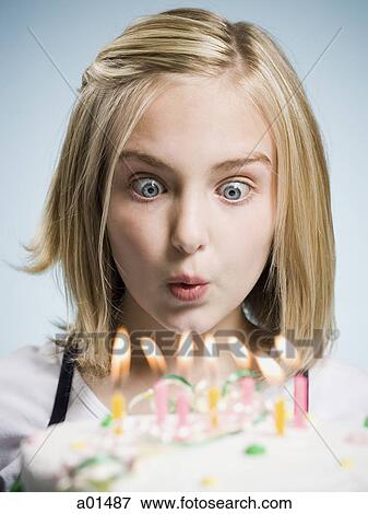 Girl blowing out candles on Birthday Cake View Large Photo Image Stock Photo - Girl blowing out candles on Birthday Cake. Fotosearch