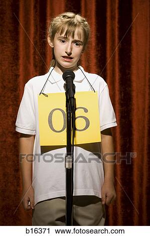 Girl contestant standing at microphone thinking View Large Photo Image Stock Image - Girl contestant standing at microphone thinking. Fotosearch