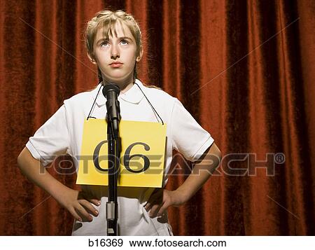 Girl contestant standing at microphone thinking View Large Photo Image Stock Photo - Girl contestant standing at microphone thinking. Fotosearch