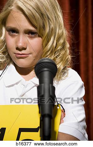 Girl contestant standing at microphone crying View Large Photo Image Stock Photo - Girl contestant standing at microphone crying. Fotosearch