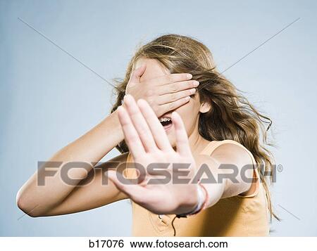 Girl covering eyes and holding out hand View Large Photo Image Stock Photograph - Girl covering eyes and holding out hand. Fotosearch