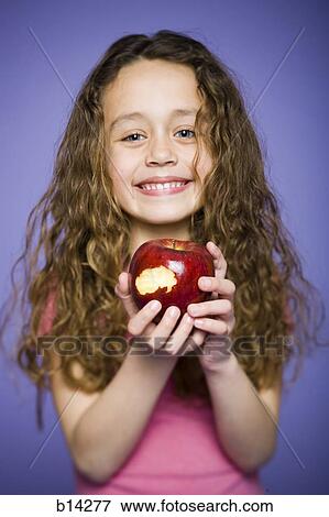 Girl eating apple View Large Photo Image Stock Photo - Girl eating apple. Fotosearch