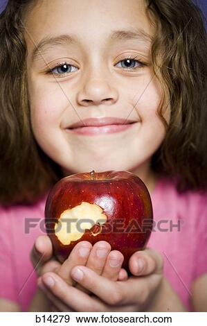 Stock Photo - Girl eating apple. Fotosearch