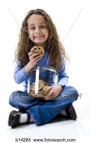 Girl eating cookies View Large Photo Image Stock Photography - Girl eating cookies. Fotosearch