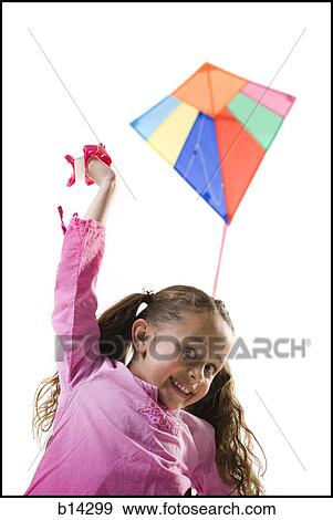 Stock Photo - Girl flying kite. Fotosearch
