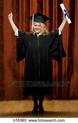 Stock Image - Girl graduate with mortar board and diploma smiling and cheering. Fotosearch