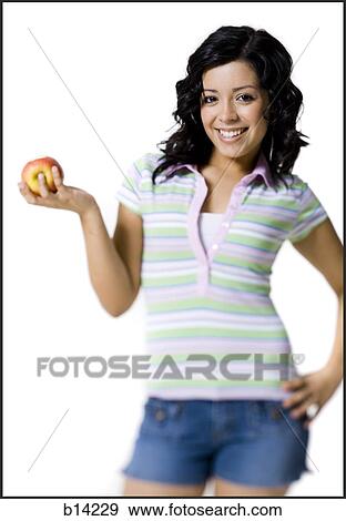 Girl holding apple View Large Photo Image Stock Photo - Girl holding apple. Fotosearch