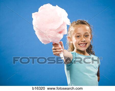 Girl holding cotton candy smiling View Large Photo Image Stock Image - Girl holding cotton candy smiling. Fotosearch