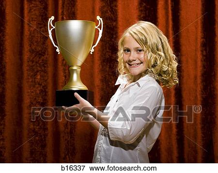 Girl holding trophy cup smiling View Large Photo Image Stock Photo - Girl holding trophy cup smiling. Fotosearch