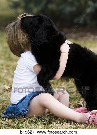 Girl hugging puppy outdoors View Large Photo Image Stock Photo - Girl hugging puppy outdoors. Fotosearch