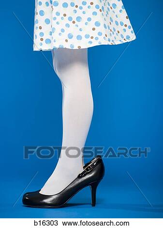Stock Image - Girl in high heeled shoes waist down profile. Fotosearch