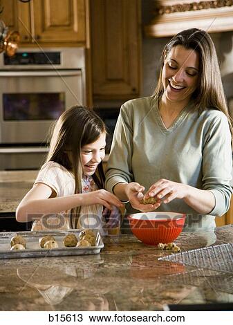 Girl in kitchen with woman baking cookies View Large Photo Image Stock Image - Girl in kitchen with woman baking cookies. Fotosearch