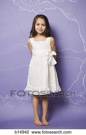 Stock Image - Girl in white dress smiling. Fotosearch