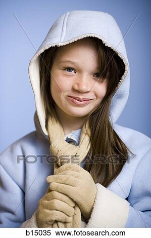 Stock Photography - Girl in winter coat and scarf smiling. Fotosearch