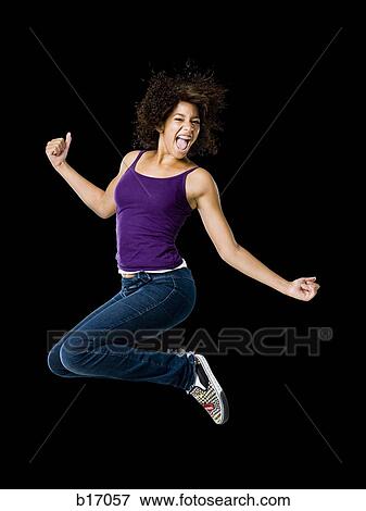 Girl leaping and smiling View Large Photo Image Stock Photo - Girl leaping and smiling. Fotosearch