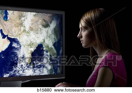 Girl looking at satellite earth image on computer monitor View Large Photo Image Stock Image - Girl looking at satellite earth image on computer monitor. Fotosearch