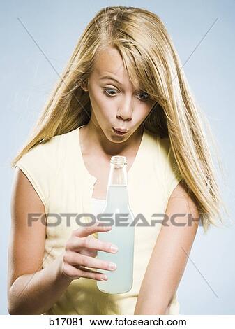 Girl looking into soda bottle View Large Photo Image Stock Image - Girl looking into soda bottle. Fotosearch