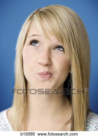 Girl looking up with puckered mouth View Large Photo Image Stock Image - Girl looking up with puckered mouth. Fotosearch