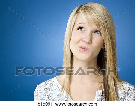 Girl looking up with puckered mouth View Large Photo Image Stock Image - Girl looking up with puckered mouth. Fotosearch