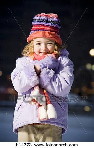 Stock Image - Girl outdoors in winter smiling. Fotosearch