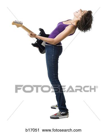 Girl playing electric guitar and singing View Large Photo Image Stock Image - Girl playing electric guitar and singing. Fotosearch