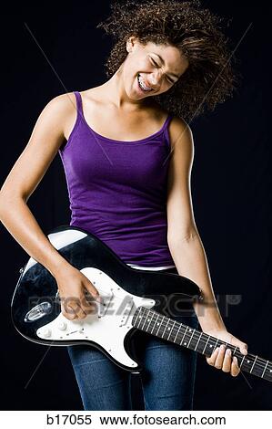 Girl playing electric guitar View Large Photo Image Stock Photography - Girl playing electric guitar. Fotosearch