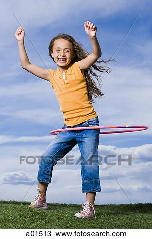 Girl playing with hula hoop outdoors View Large Photo Image Stock Image - Girl playing with hula hoop outdoors. Fotosearch
