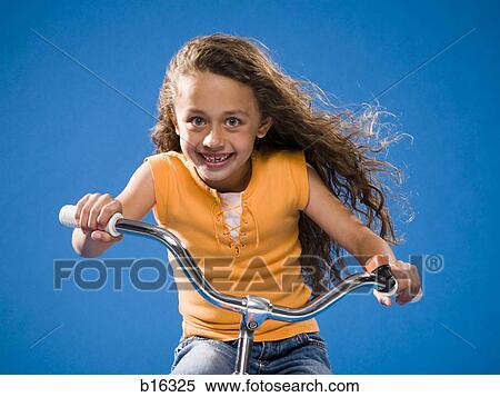 Girl riding bicycle and smiling View Large Photo Image Stock Photography - Girl riding bicycle and smiling. Fotosearch
