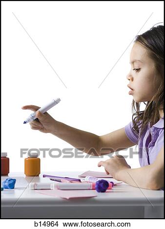 Girl sitting at table doing crafts View Large Photo Image Picture - Girl sitting at table doing crafts. Fotosearch