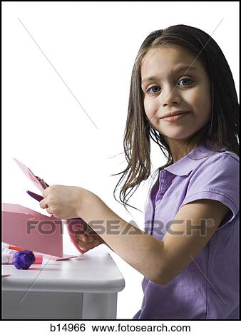 Girl sitting at table doing crafts View Large Photo Image Stock Photograph - Girl sitting at table doing crafts. Fotosearch