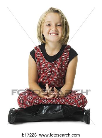 Stock Image - Girl sitting cross legged smiling. Fotosearch