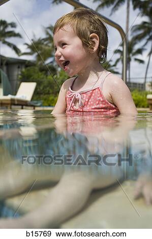 Stock Photo - Girl sitting in outdoor pool smiling. Fotosearch